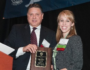 Sam Jones, chapter president, recognizes Stephanie Spano, the January Young AFCEAN.